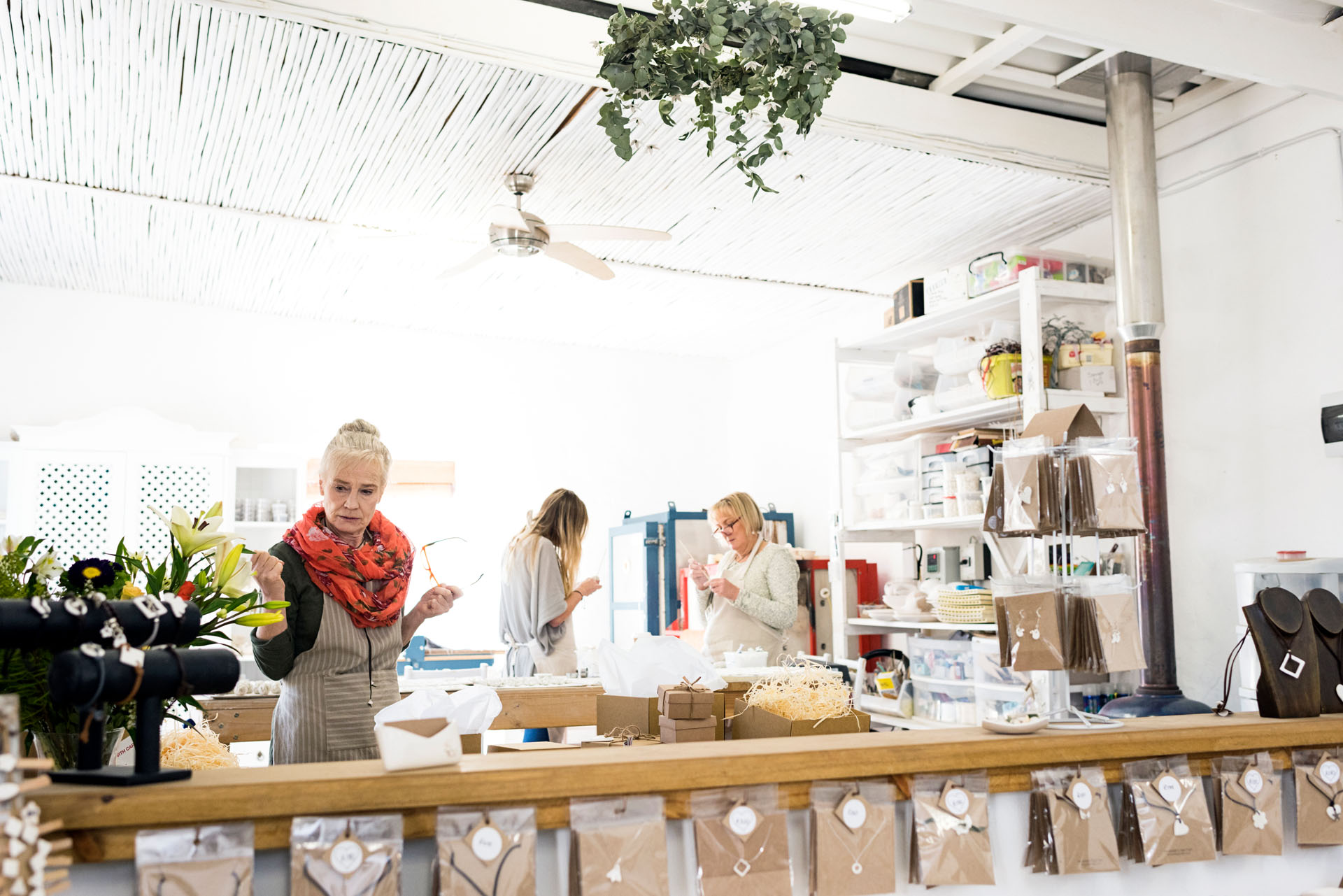 Senior women standing behind counter in porcelain workshop